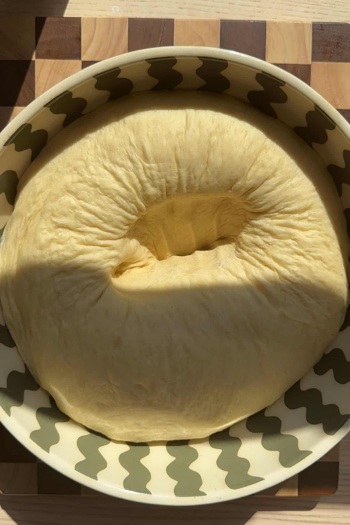 Dough that has risen in a glass bowl.