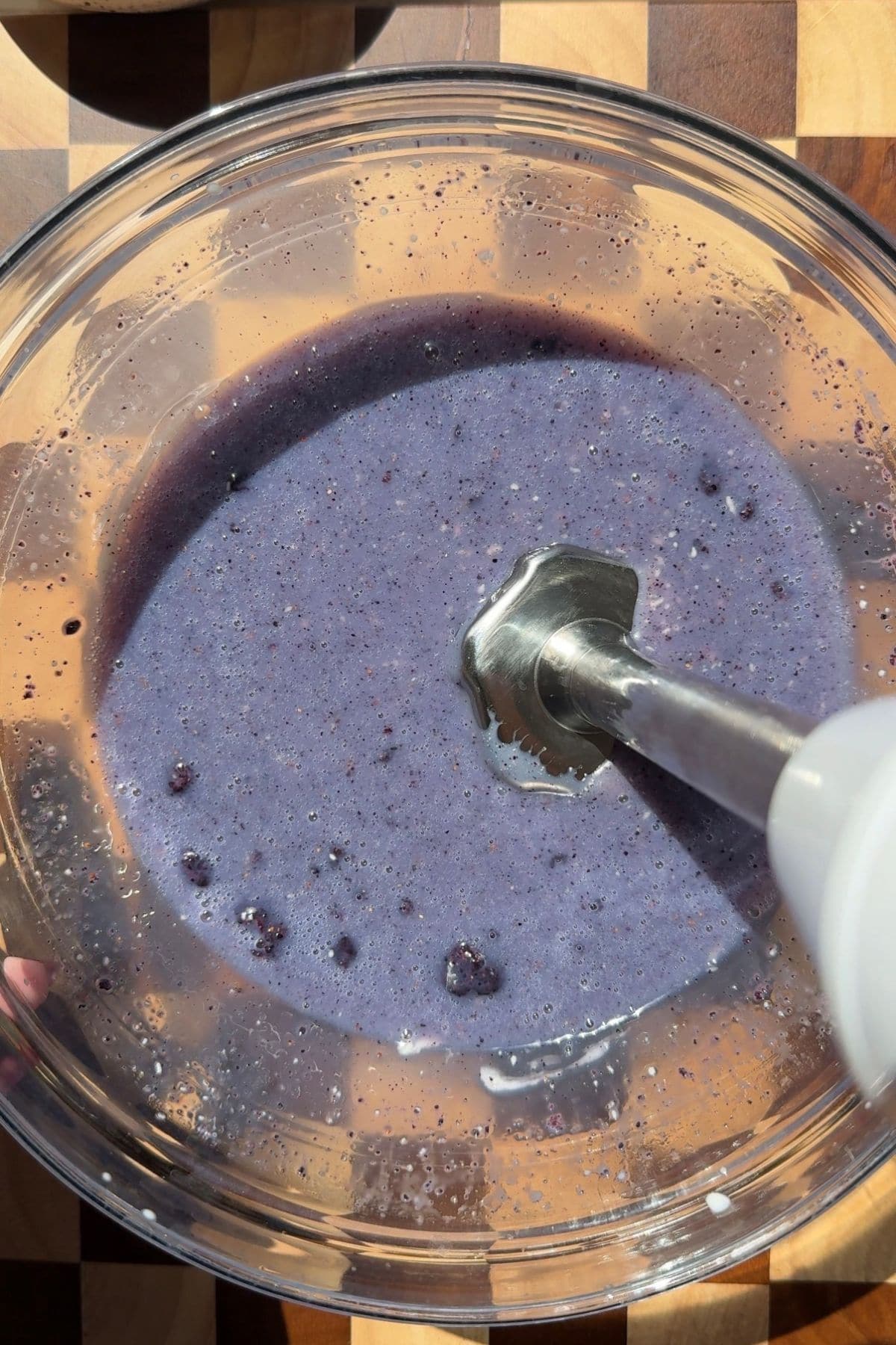 Ganache in a bowl with an immersion blender.