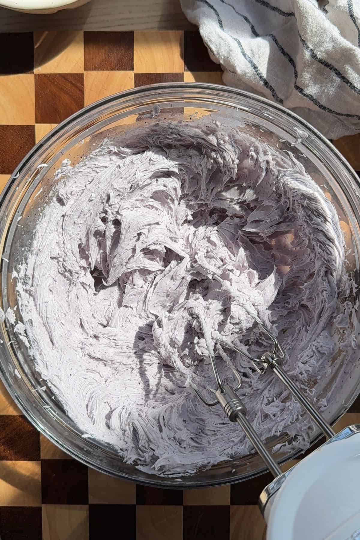 Whipping ganache with a hand mixer.