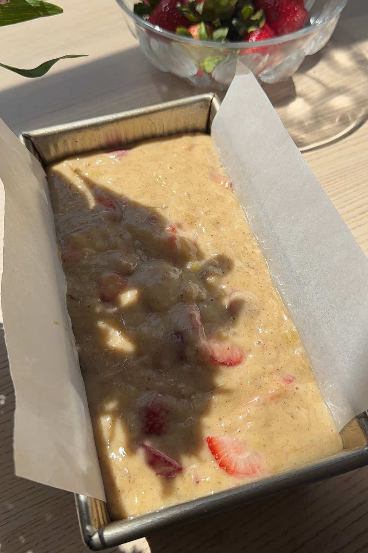 Unbaked banana bread batter in a loaf pan.