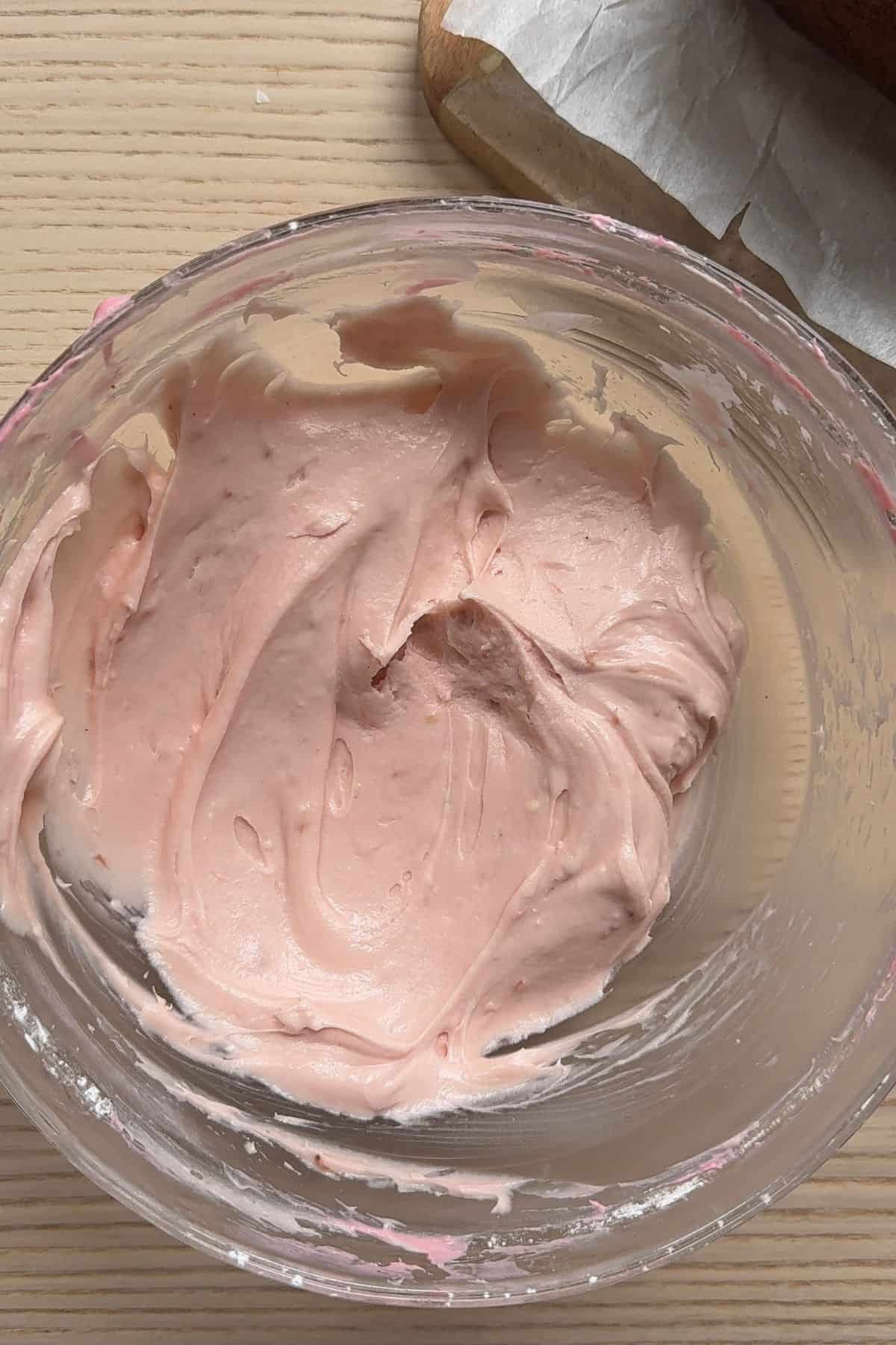 Strawberry cream cheese frosting in a bowl.