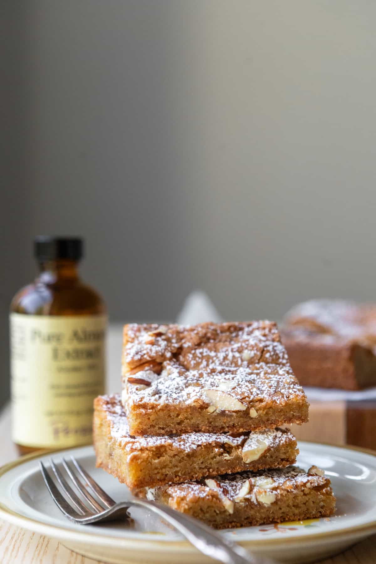 A stack of blondies on a plate with a fork.
