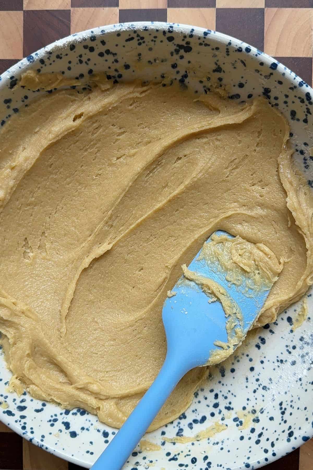Batter in a bowl with a rubber spatula.