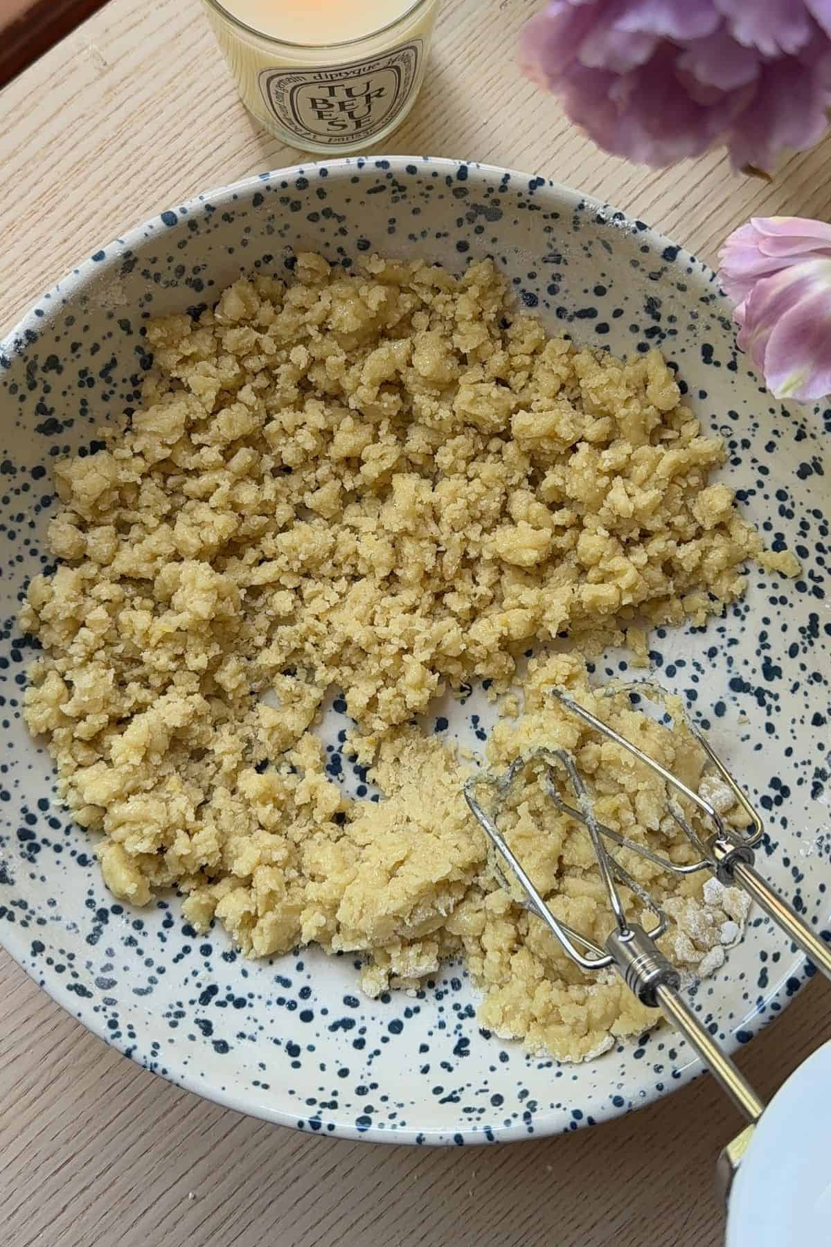 Oil mixed into dry ingredients in a bowl.