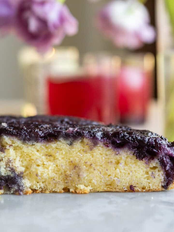 Close up of a blueberry upside down cake cut open.