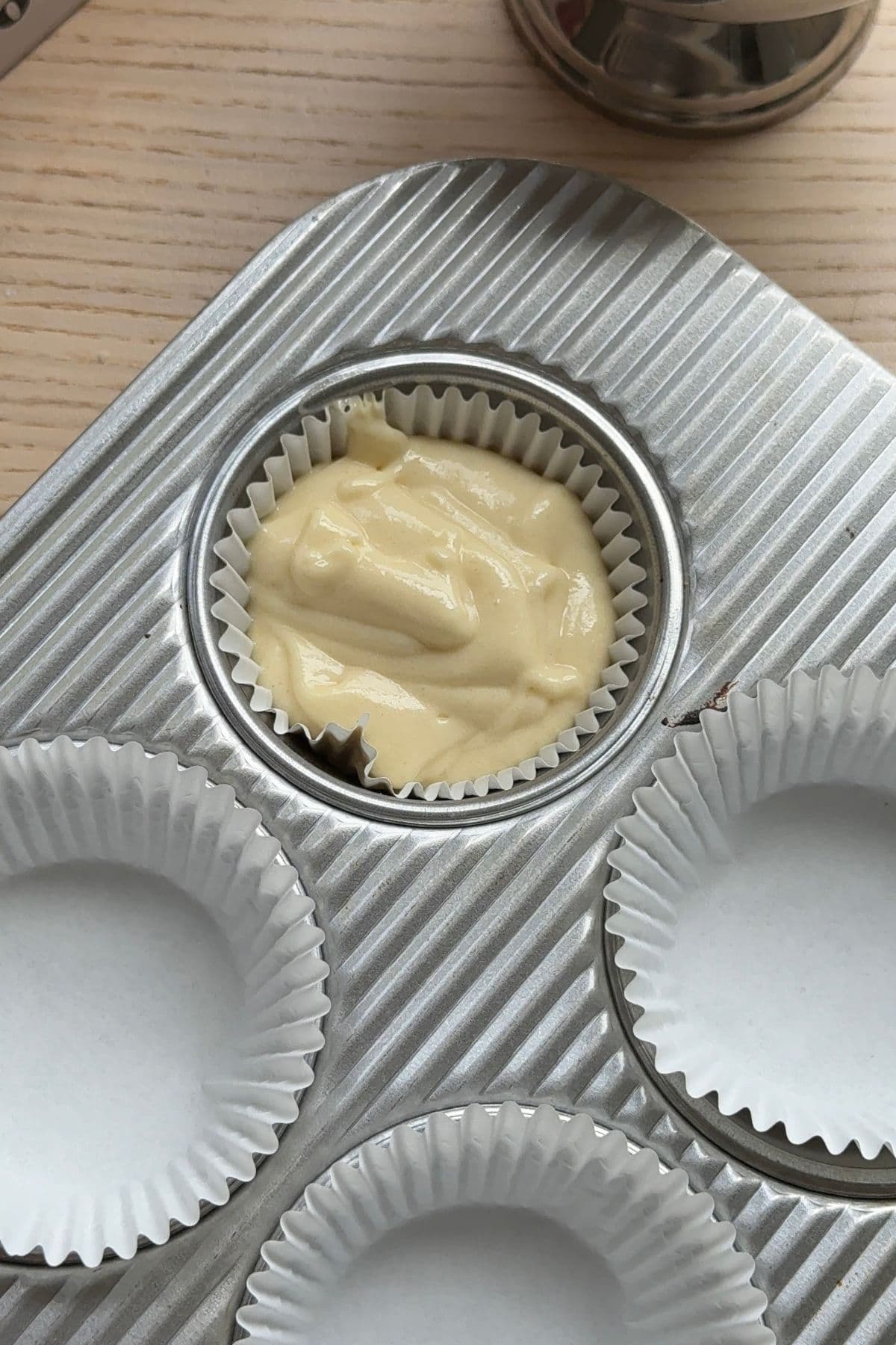 An unbaked cupcake in a cupcake pan.