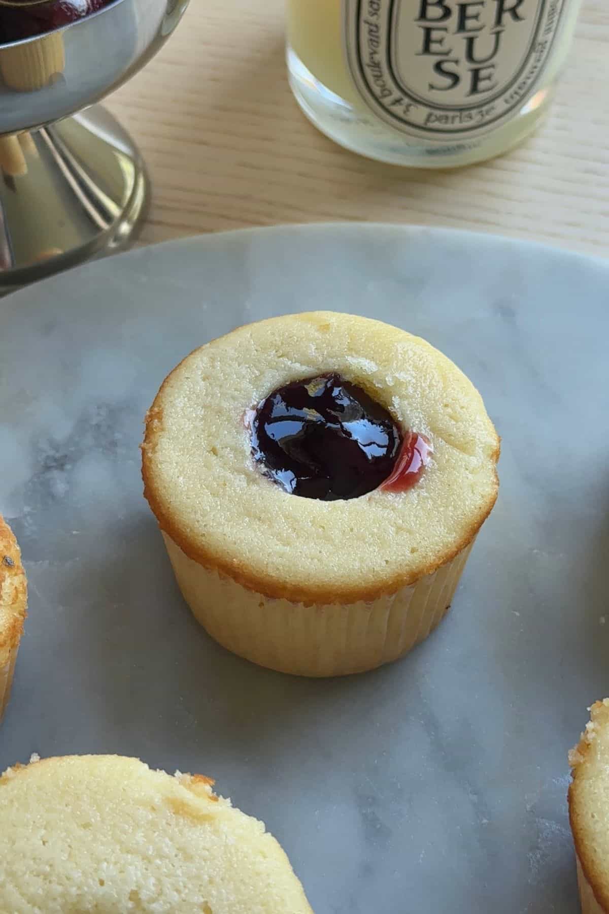 A cupcake filled with cherry jam.