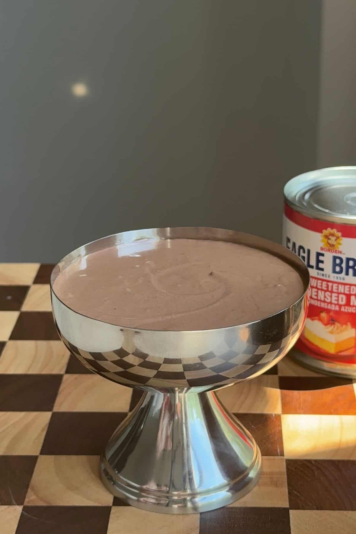 Mousse in a stainless steel serving cup.