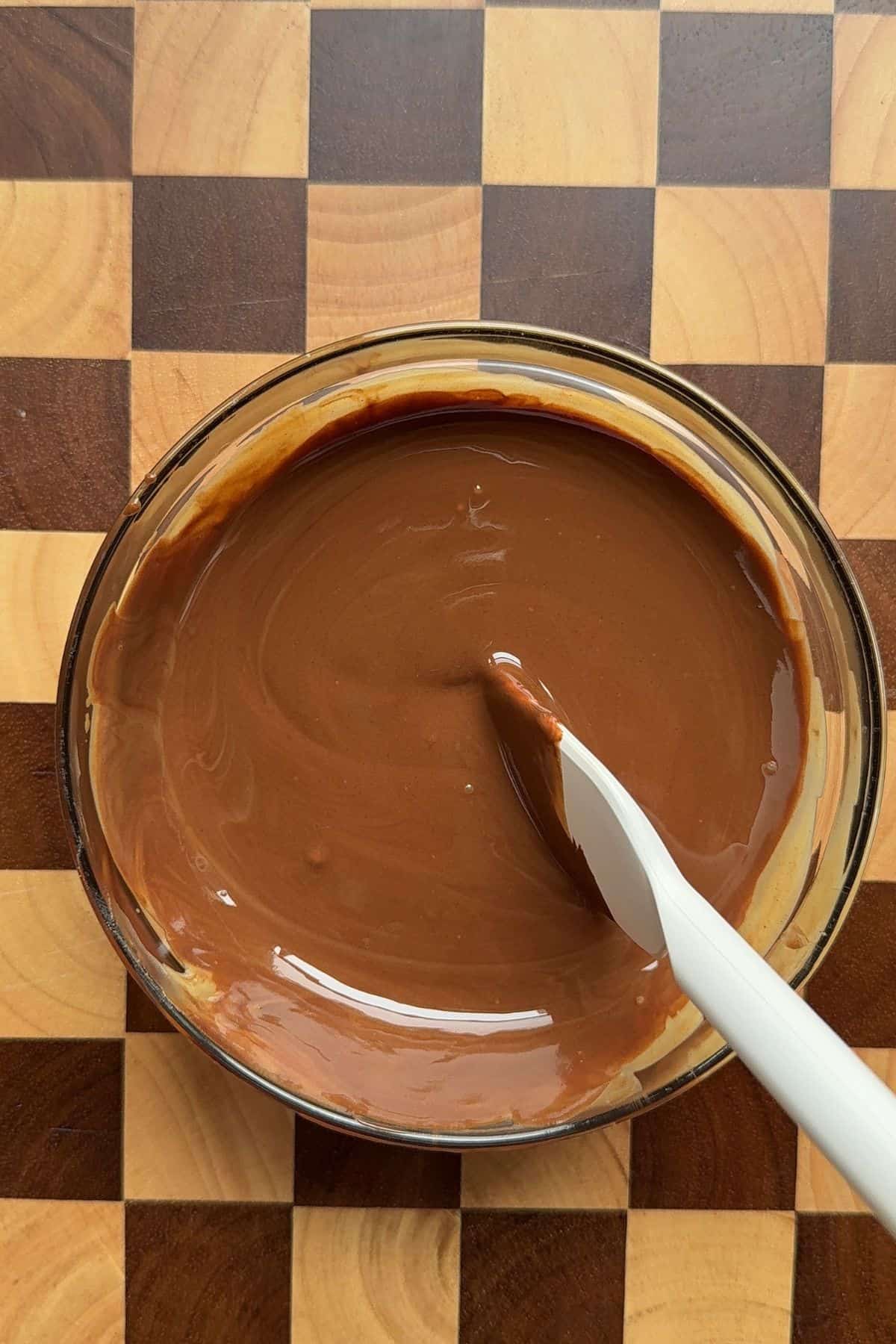 Melted chocolate and peanut butter mixed in a bowl.