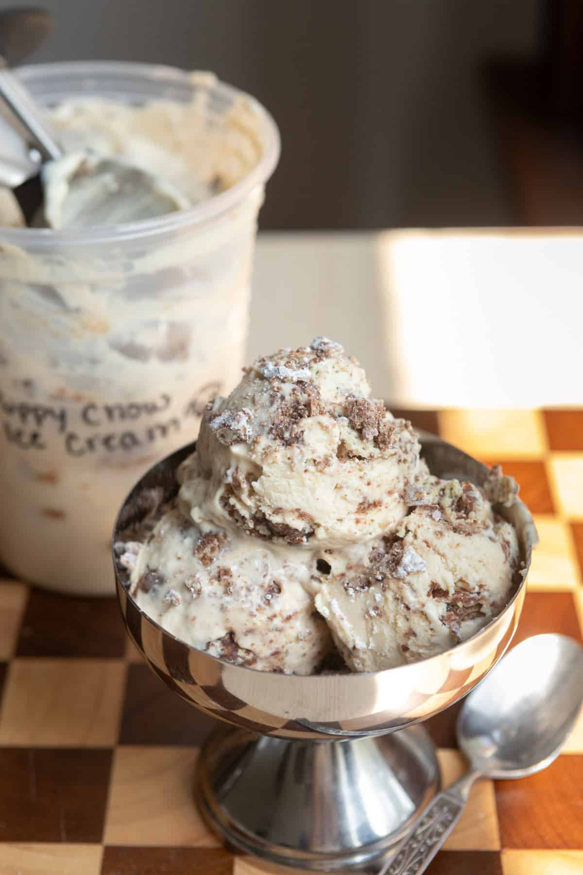 Ice cream scooped into a metal bowl.