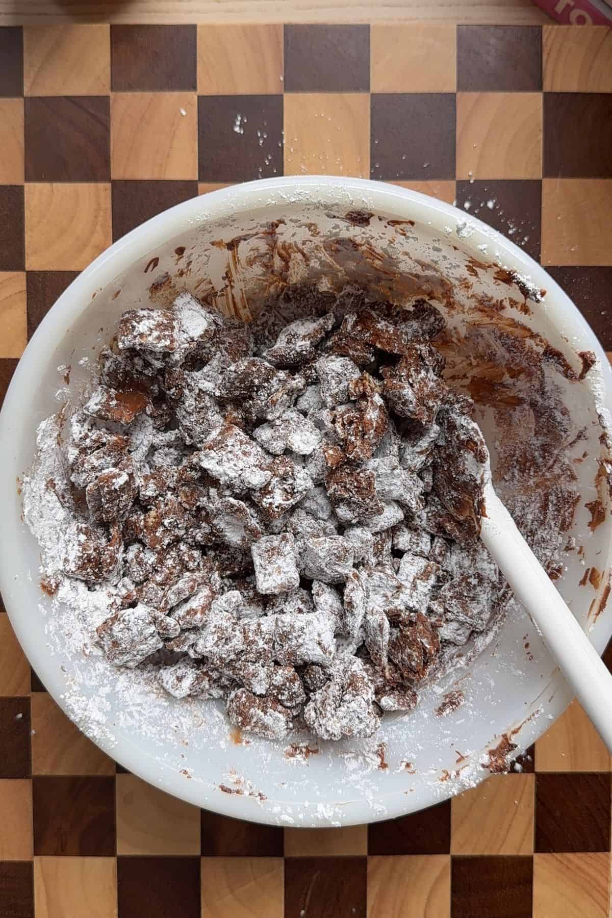 Puppy chow in a white bowl.