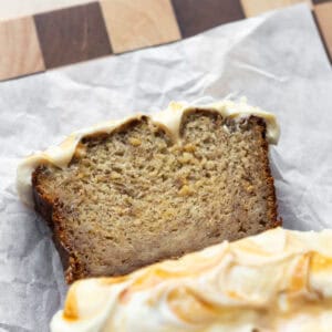 Salted caramel banana bread sliced on parchment.