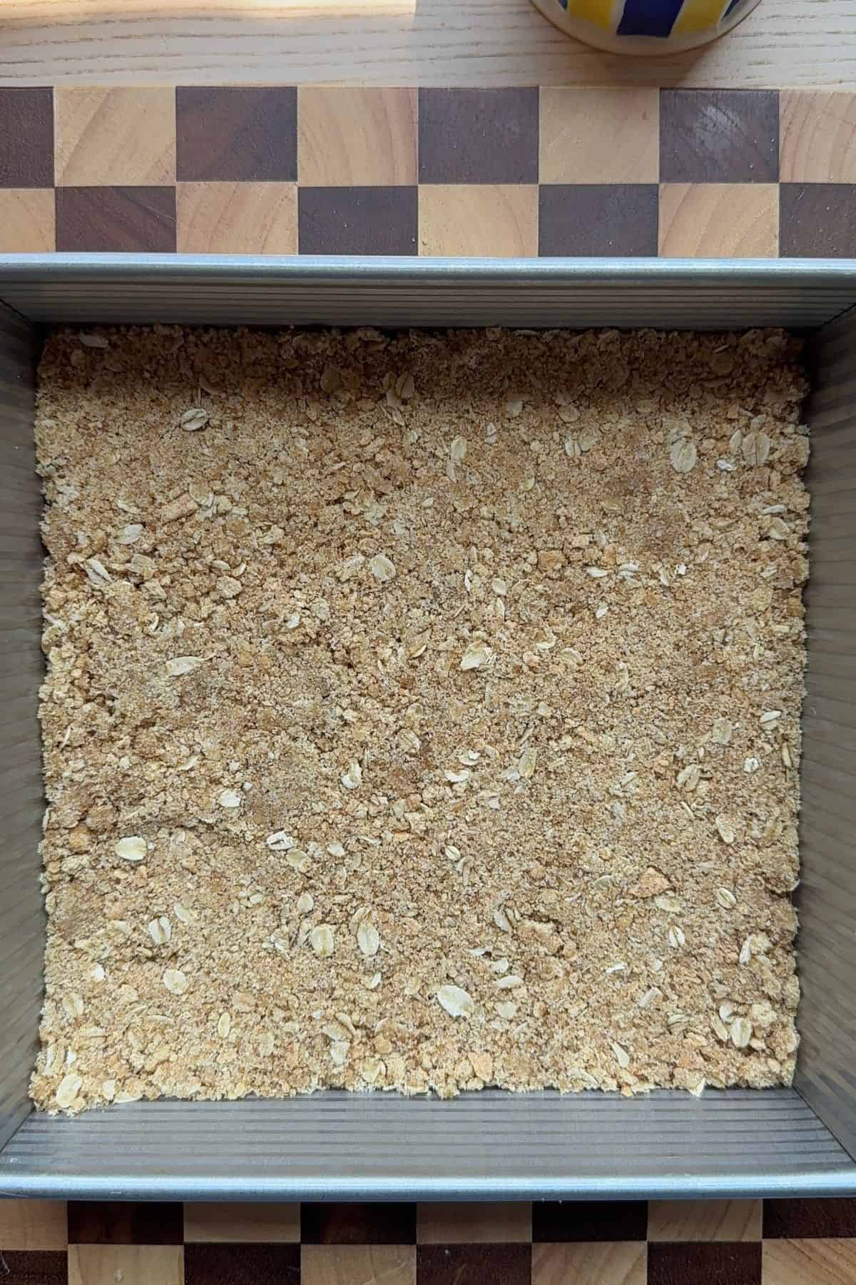 Crust pressed into a square baking pan.