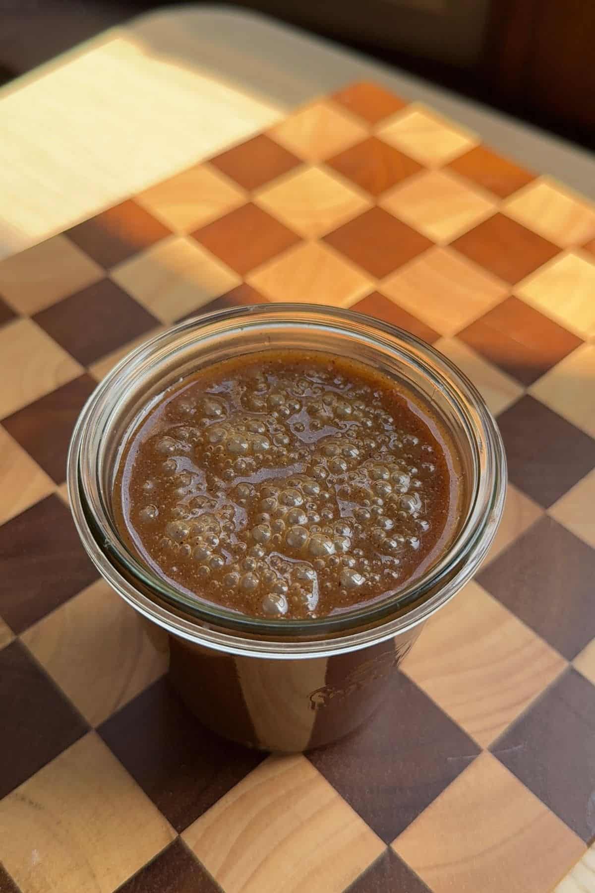 Butterscotch sauce in a glass jar.