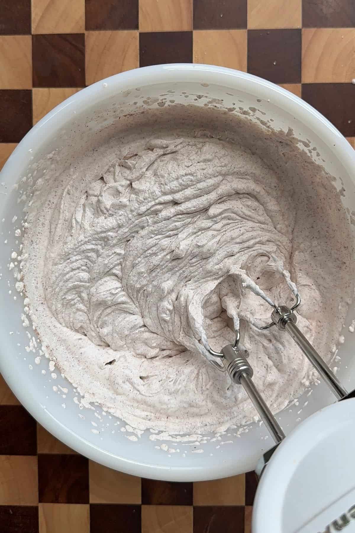 Heavy cream and cinnamon whipped together in a bowl.