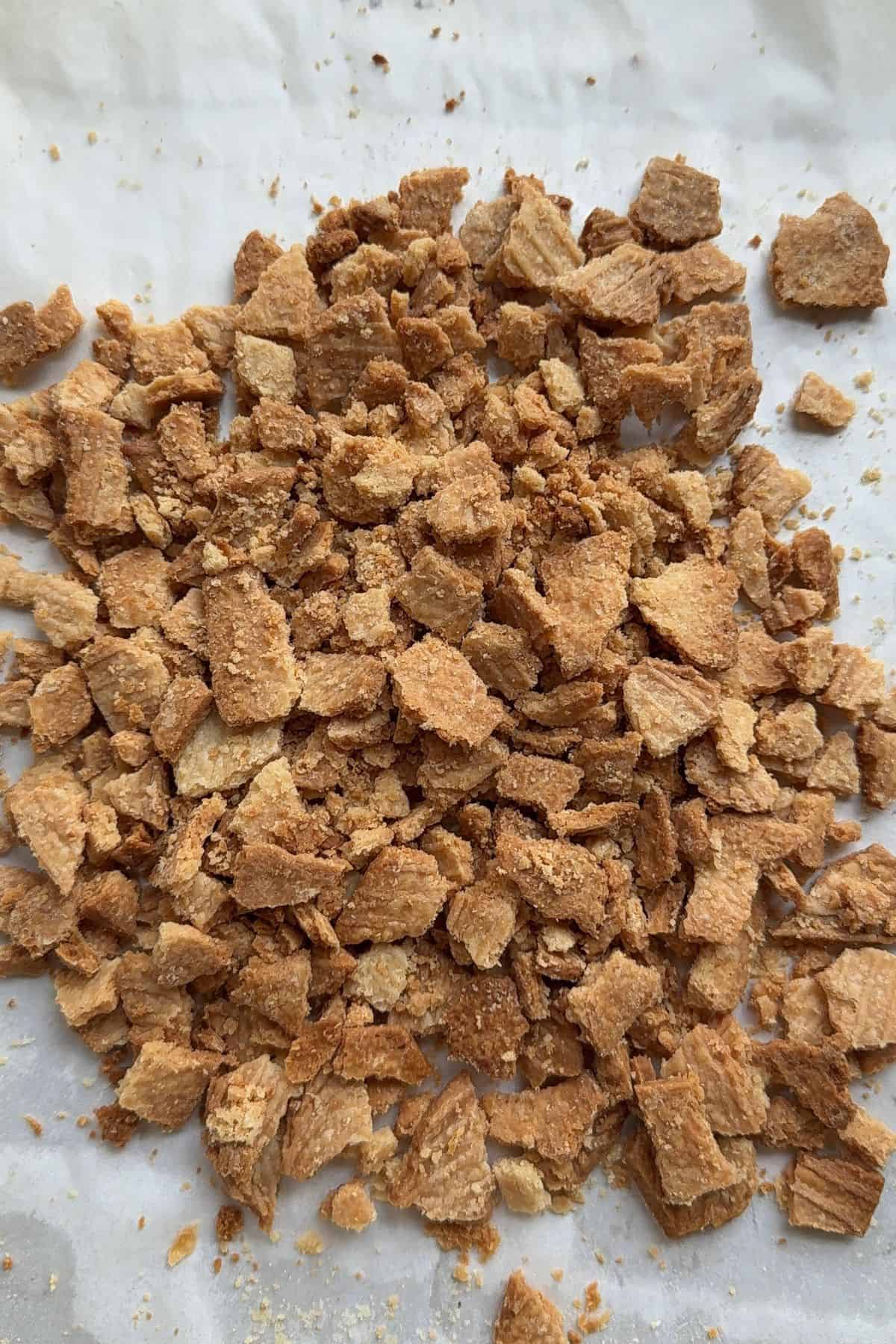 Pie crust crumbs on parchment paper.