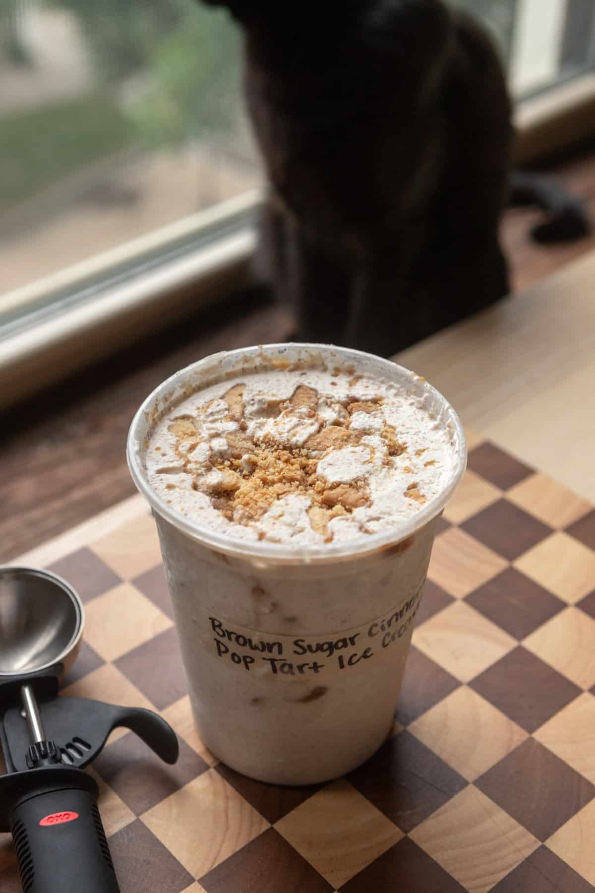 A deli container full of brown sugar cinnamon pop tart ice cream.