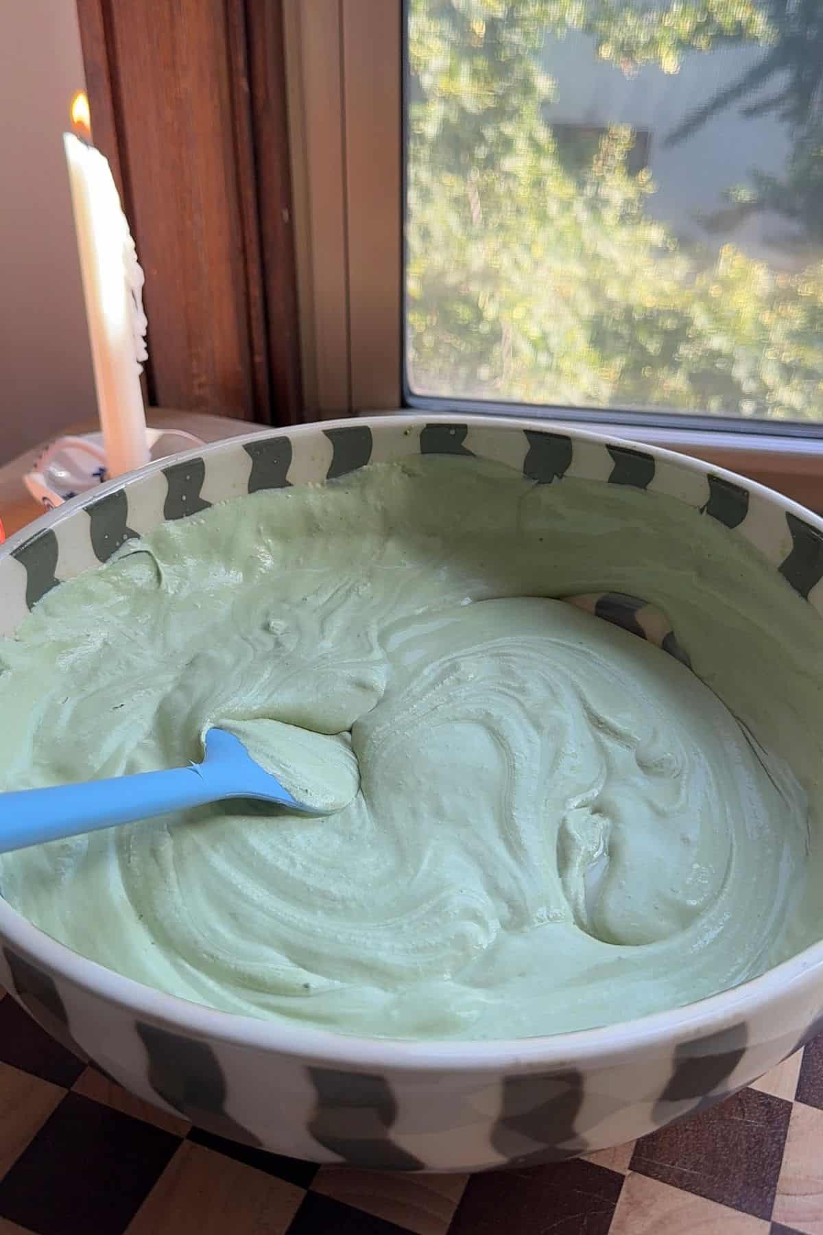 No-churn matcha ice cream base in a large mixing bowl.