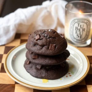 A stack of 3 muffin tops on a plate.