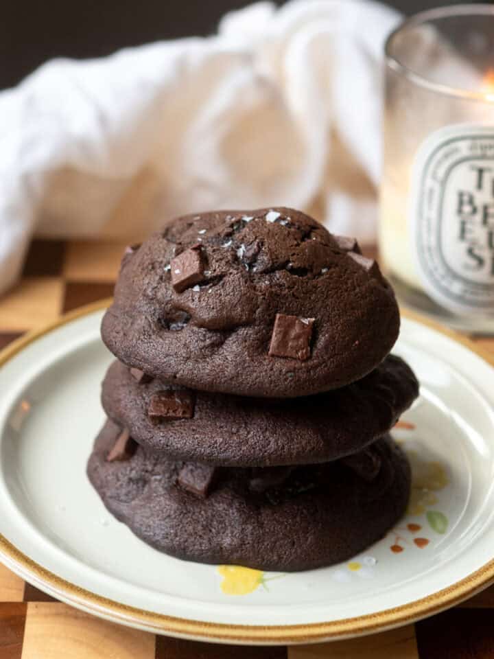 A stack of 3 muffin tops on a plate.