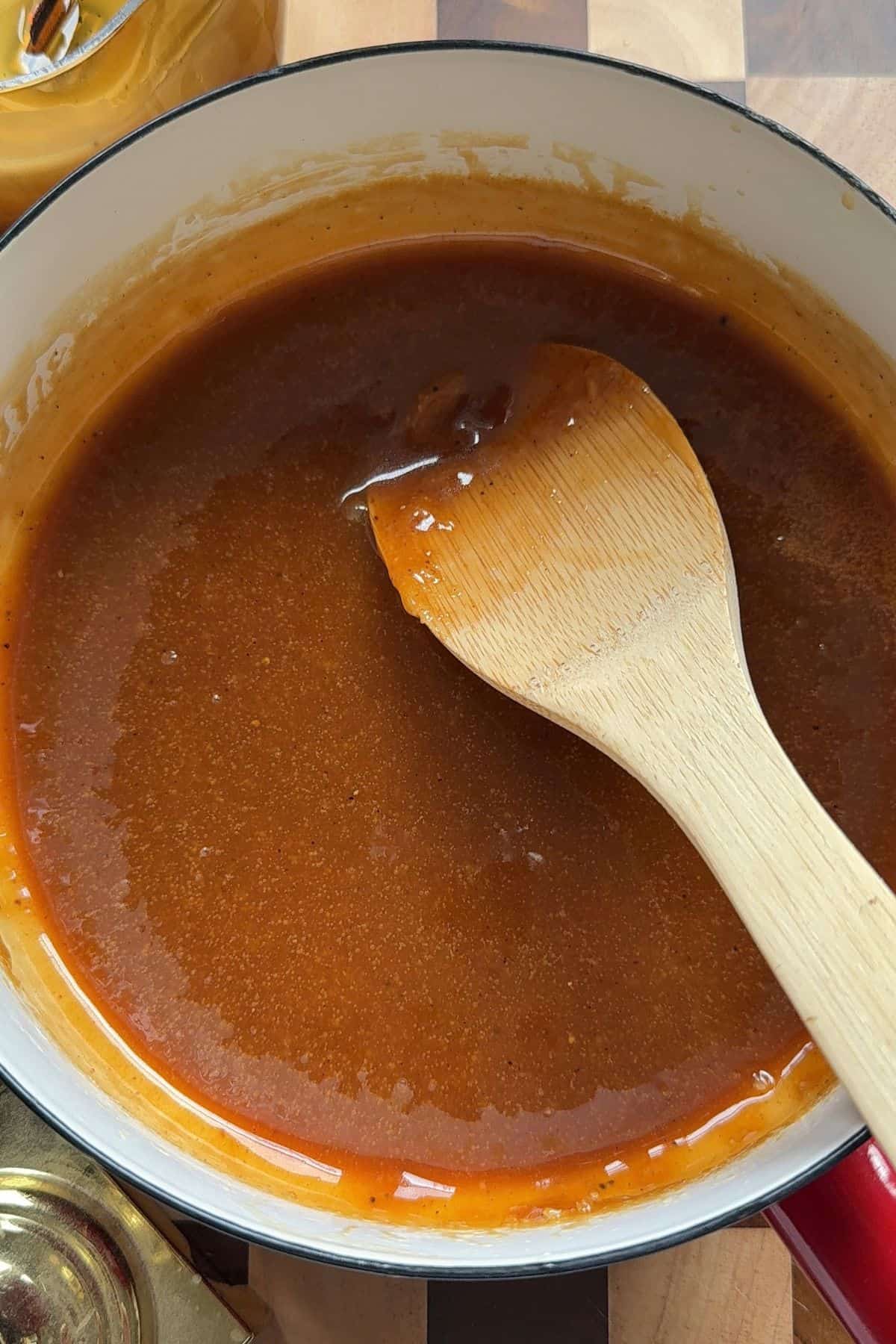 Caramel in a saucepan with a wooden spoon.
