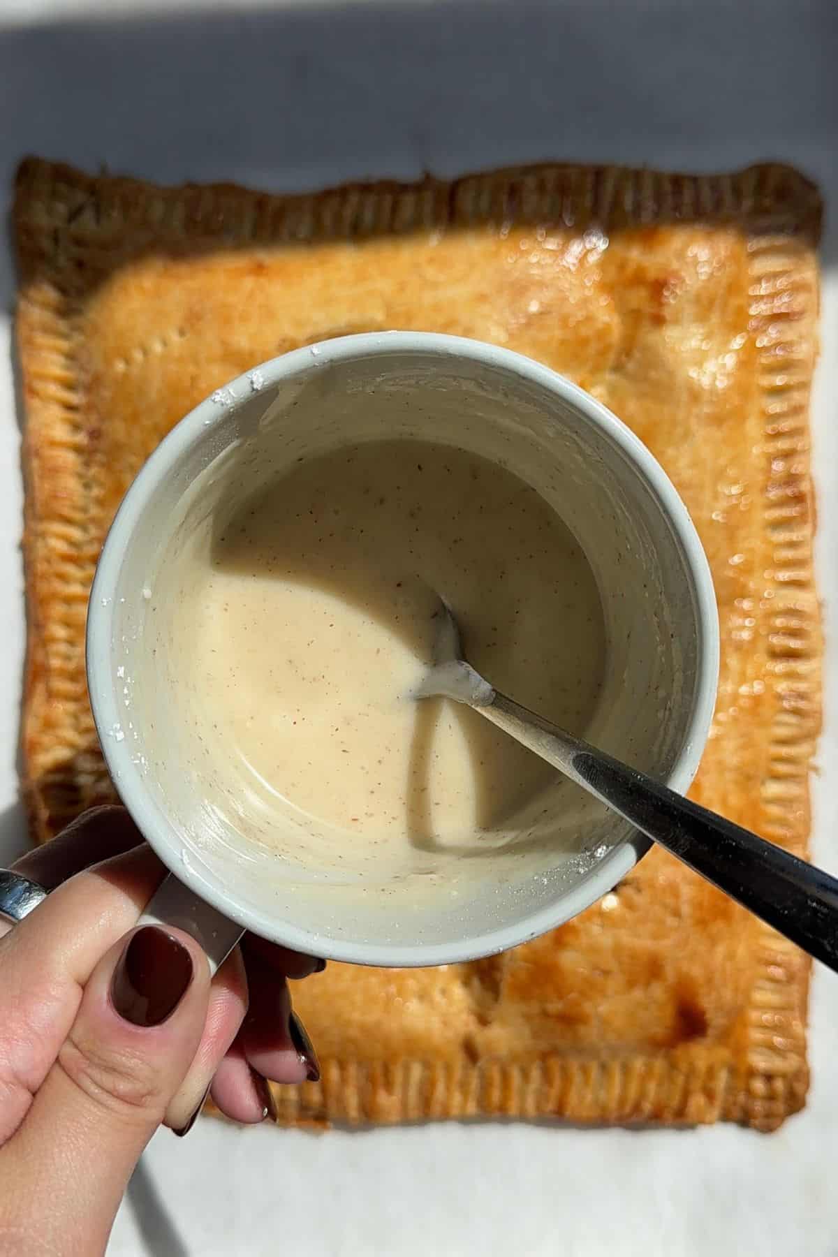 Icing in a bowl with a fork in it.