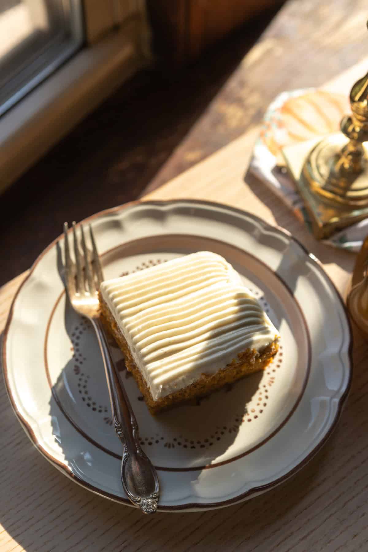 A slice of cake on a plate with a fork.