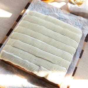 A square pumpkin cake with cream cheese frosting.