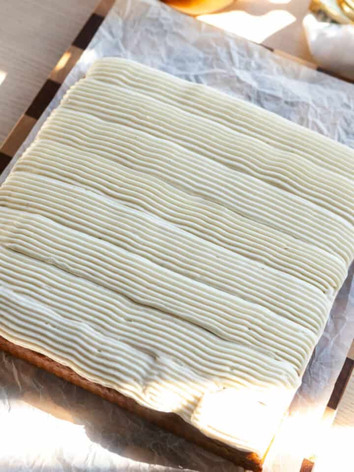 A square pumpkin cake with cream cheese frosting.